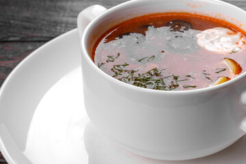 Appetizing dish of russian hodgepodge soup in ceramic pot