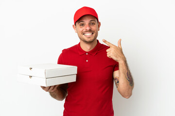 pizza delivery man with work uniform picking up pizza boxes over isolated  white wall giving a...