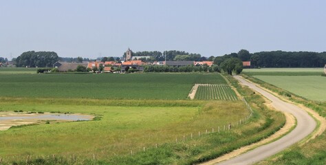 the little city Baarland behind the fields with onions in the dutch countryside in zeeland