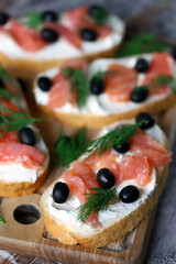 Sandwiches with salmon, cream cheese and olives. Healthy food.