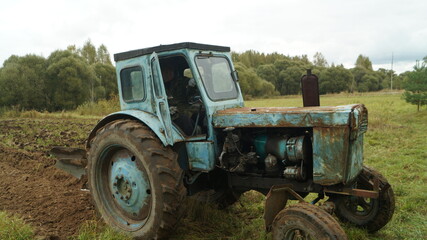 tractor ploughs arable land, an agricultural concept