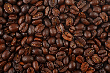 Roasted coffee beans as background, top view. Black coffee beans.