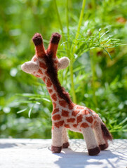 Toy handmade giraffe, felting wool, rear view