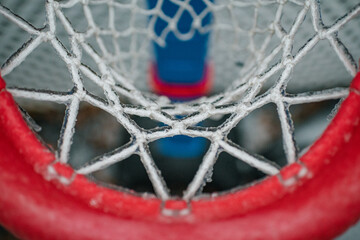 Frozen basketball hoop and net