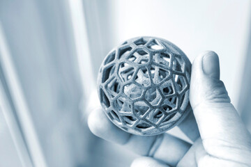 Person holding object printed on powder 3D printer from powder polyamide