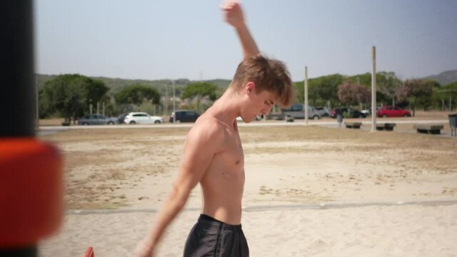 Young man warming up his shoulders before calisthenics workout.