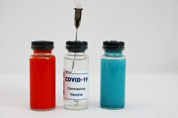 Three ampoules with covid-19 vaccine and a syringe on a white background.