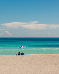Fototapeta na wymiar Gorgeous beach day with beach chairs and umbrella