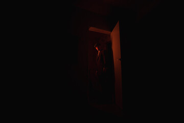 man in a doorway in the dark.