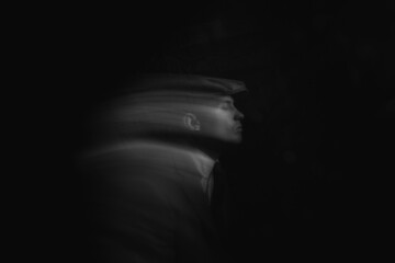 blurred portrait of a man in the dark