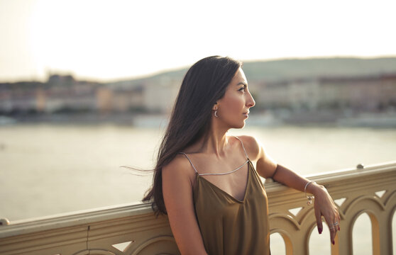 beautiful woman looks at panorama from a bridge