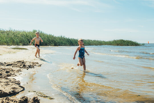 Children playing on the lake. Concept of friendly family.