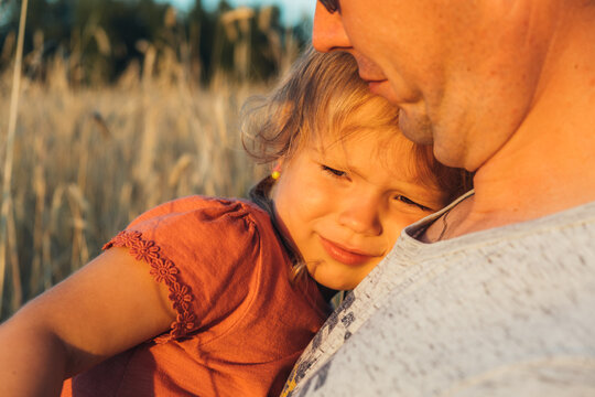 Father holding his little daughter. Concept of friendly family.