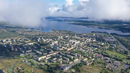 Forest, village on the shore of a large lake or sea. Autumn nature from above.