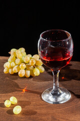 red wine and grapes on a dark background