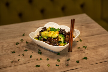 Traditional Chinese cucumber seaweed salad served with chopsticks
