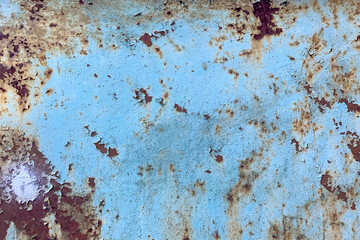 Damaged old peeling paint blue background rusty metal flat pallet. Cracked oil paint on aged metal surface. Close-up.