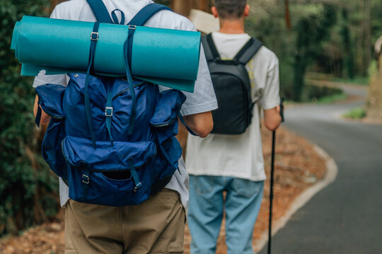 young people with backpacks practicing hiking