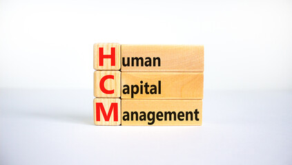 HCM, Human capital management symbol. Concept words HCM, Human capital management on wooden blocks on a beautiful white background. Business, HCM, Human capital management concept. Copy space.