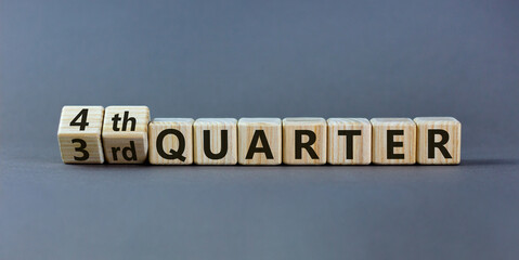 From 3rd to 4th quater symbol. Turned wooden cubes and changed words '3rd quater' to '4th quater'. Beautiful grey table, grey background. Business, happy 4th quater concept, copy space.