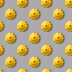 Seamless pattern with yellow bush pumpkin on a gray background. Top view