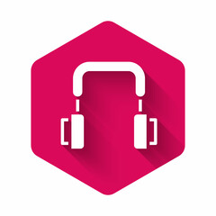 White Headphones icon isolated with long shadow background. Earphones. Concept for listening to music, service, communication and operator. Pink hexagon button. Vector