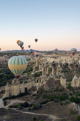 Colorful hot air balloons in the sunrise autumn morning. Goreme National Park, Cappadocia, Turkey. Aerial view