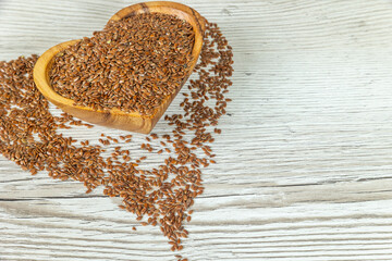 Flax seeds in wooden bowl. Close up.