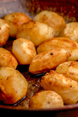 Whole fried potatoes in a pan