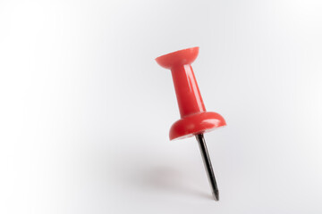 Red pin isolated on white background.