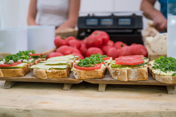 Healthy homemade sandwiches with natural products and tomatoes in the background