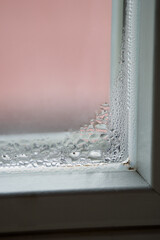 Dew glass in the interior in the corner of the window frame.