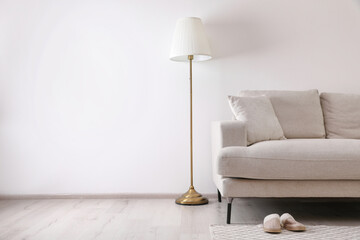 Interior of living room with comfortable sofa and floor lamp