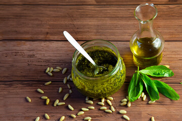 preparation of Genoese pesto, the sauce ready in the glass jar, pine nuts , olive oil and basil leaves