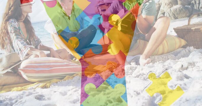 Animation of colourful puzzle pieces hand over happy friends at summer beach party