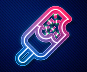 Glowing neon line Ice cream icon isolated on blue background. Sweet symbol. Vector