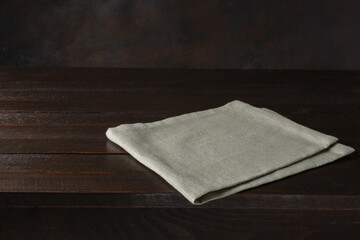 Wood cutting board and napkin on wooden table and spice, pepper, salt.