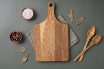 Wood cutting board and napkin on wooden table and spice, pepper, salt.