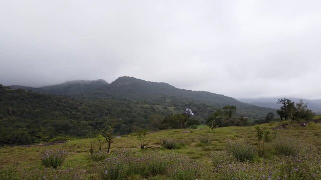 A Dramatic view of the Kote betta Hill range with landscapes and a natural Waterfall during Monsoon in Coorg which is an ideal getaway for the weekend
travelers across the Karnataka state in India.