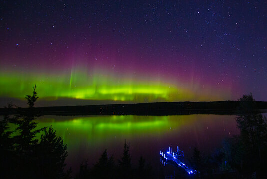 Northern Lights in Canada reflecting on a lake