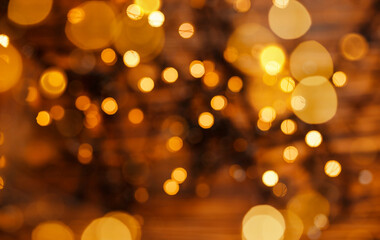 Beautiful shiny Christmas lights. Glowing magic bokeh. Defocused gold lights. Abstract holiday...