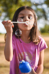 girl blowing bubbles