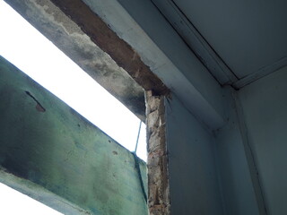 Broken and damaged window frame. Cement or brick cracked concept. 