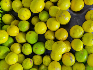 Fresh organic lemons kept together in a stall of a retail market