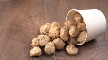 Raw soya chunks on dark background. Healthy, nutritious soybean meat, chunks isolated.Vegan food concept.