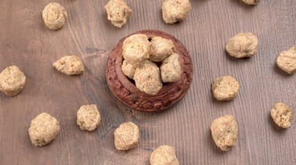 Raw soya chunks on dark background. Healthy, nutritious soybean meat, chunks isolated.Vegan food concept.