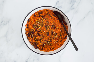 vegan chilli sin carne with black beans and red lentils in spicy tomato sauce, healthy plant-based food