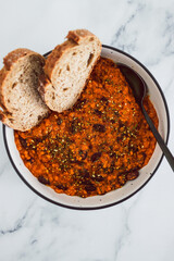 vegan chilli sin carne with black beans and red lentils in spicy tomato sauce, healthy plant-based food