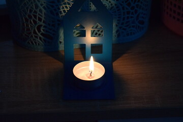 Burning small blue candle. Isolated objects.