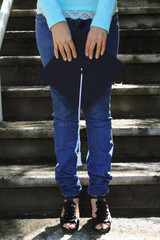 Sosteniendo el birrete frente a escaleras